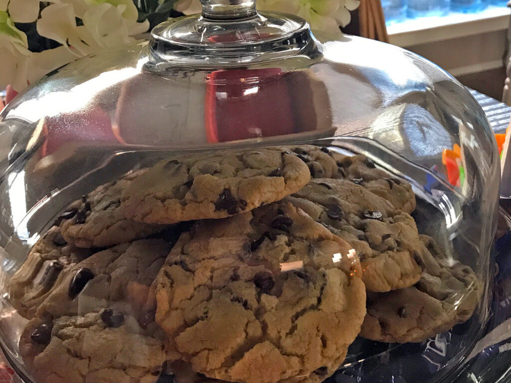 Freshly baked, warm and delicious Coco's Cookies under glass.